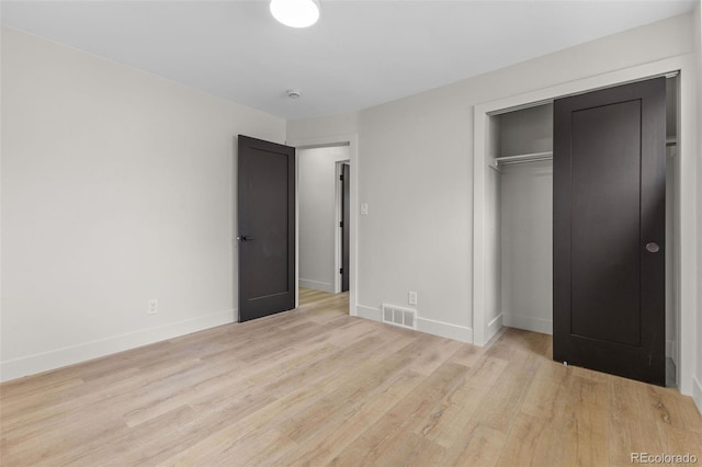 4580 Garland St, Wheat Ridge, CO 80033 - unfurnished bedroom featuring light wood-style flooring, baseboards, and a closet