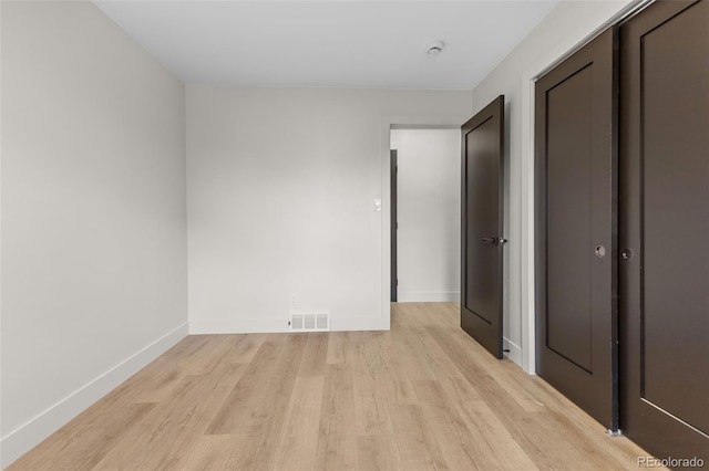 4580 Garland St, Wheat Ridge, CO 80033 - unfurnished bedroom featuring light wood-style floors, baseboards, and a closet