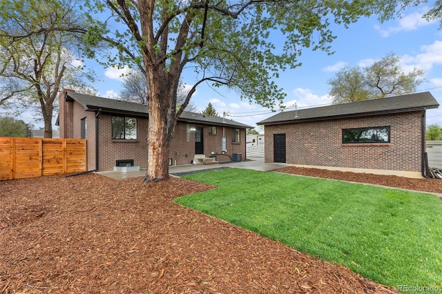 4580 Garland St, Wheat Ridge, CO 80033 - back of house featuring brick siding, a patio area, a shingled roof, and central air condition unit