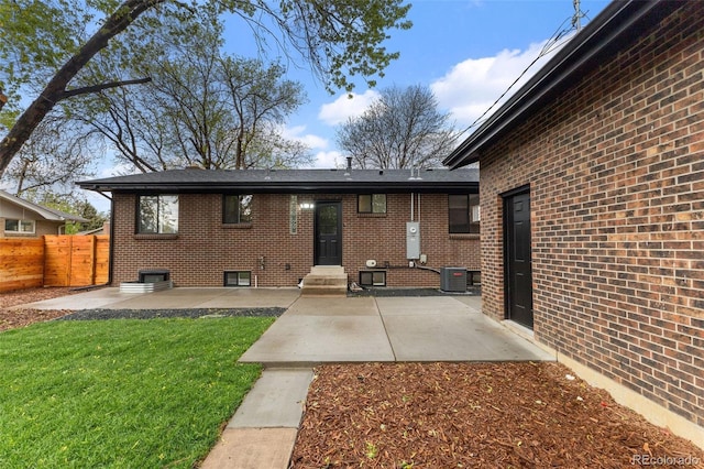 4580 Garland St, Wheat Ridge, CO 80033 - rear view of property featuring central air condition unit, entry steps, a patio area, and brick siding