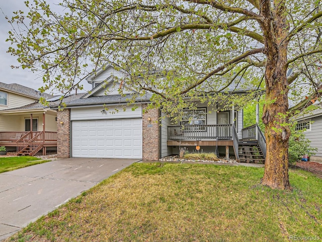 view of front facade with a porch, brick siding, an attached garage, concrete driveway, and a front lawn