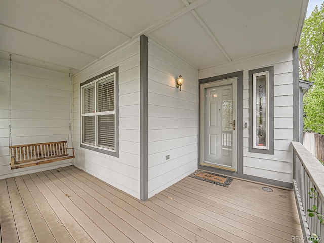 view of exterior entry with a porch