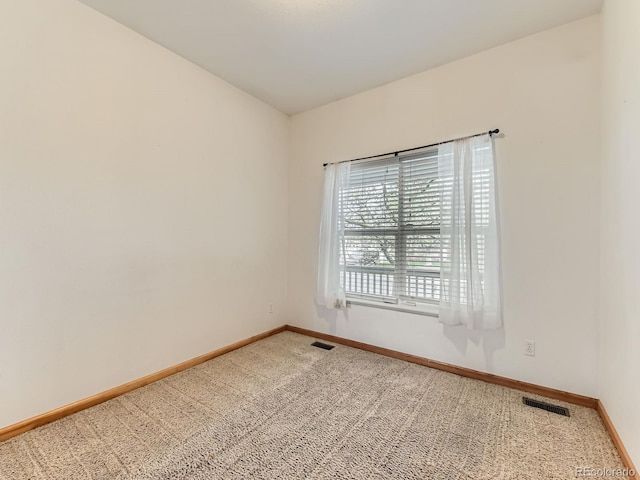 carpeted spare room with baseboards