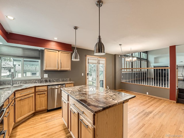 kitchen with stainless steel dishwasher, a sink, plenty of natural light, light wood-type flooring, and recessed lighting
