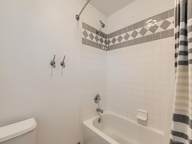 bathroom featuring toilet and shower / bath combo