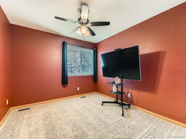 workout room featuring ceiling fan, carpet flooring, and baseboards