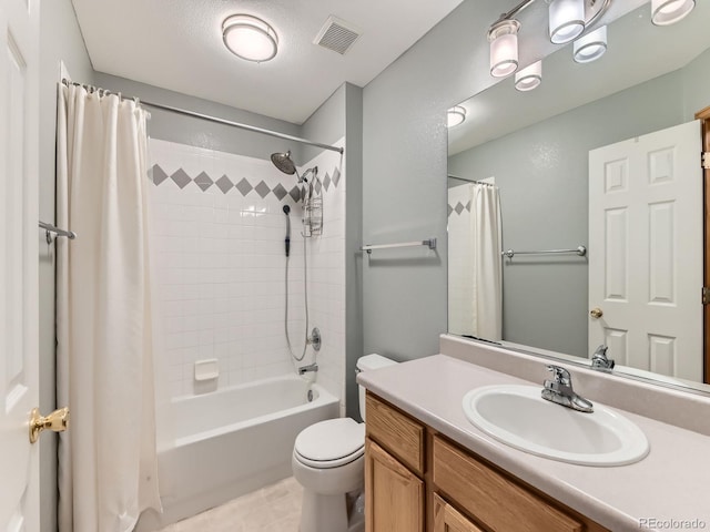 bathroom with toilet, shower / tub combo, vanity, and tile patterned floors