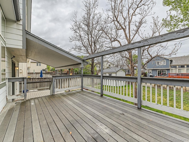 wooden deck with a yard and a residential view