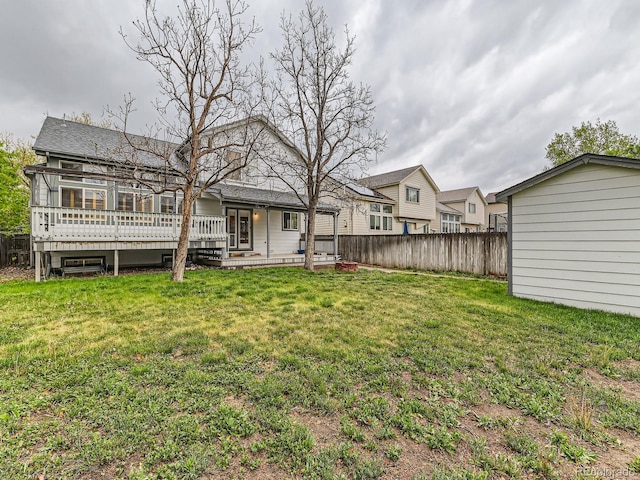 rear view of house featuring a wooden deck