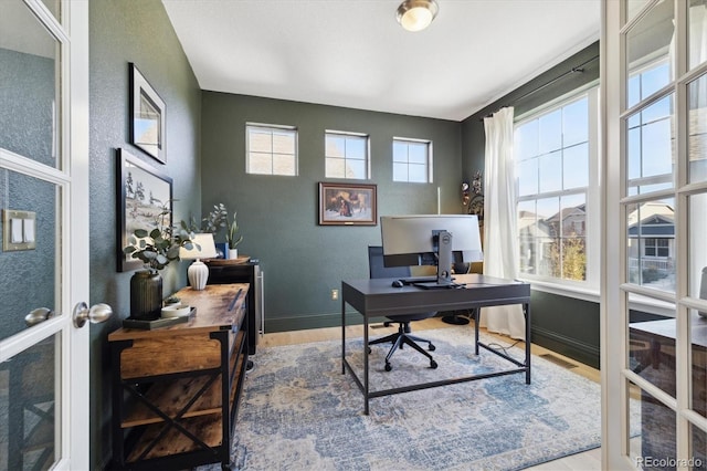 office space with baseboards and wood finished floors