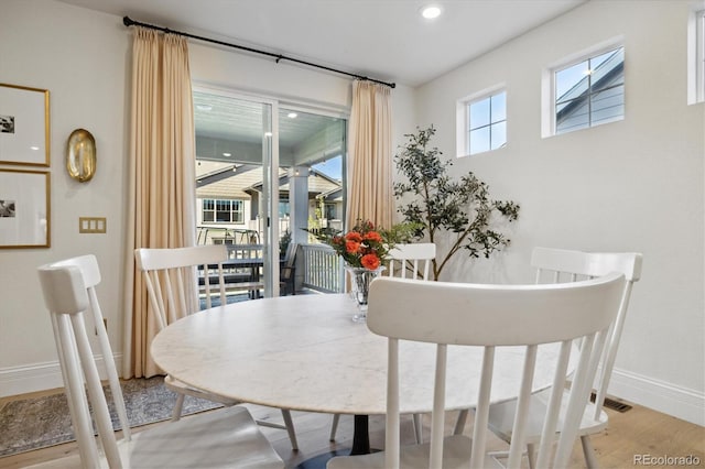 dining area featuring light wood-style floors, baseboards, and recessed lighting