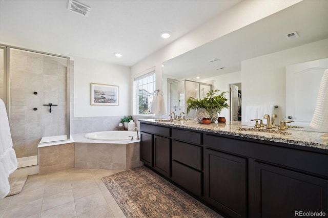 bathroom featuring a sink, tile patterned floors, a shower stall, visible vents, and a bath