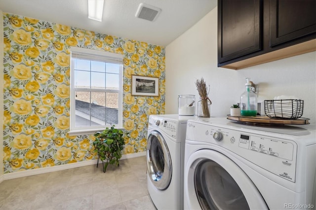 clothes washing area with separate washer and dryer, wallpapered walls, visible vents, and baseboards