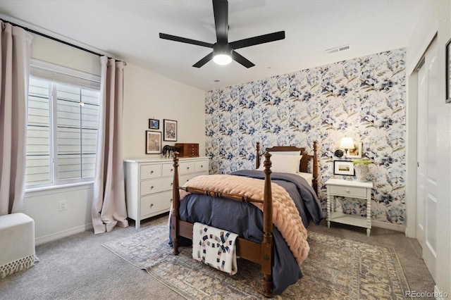 bedroom featuring wallpapered walls, visible vents, and carpet