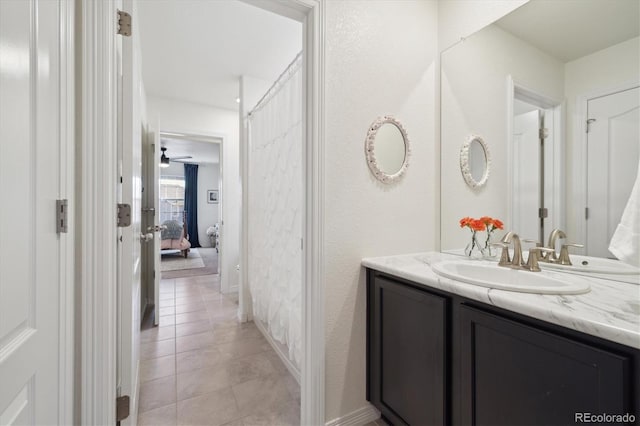bathroom featuring tile patterned floors, baseboards, and vanity