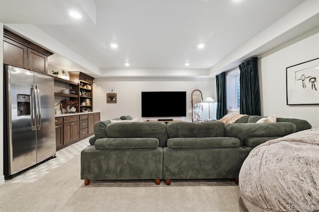 living area featuring recessed lighting and a tray ceiling