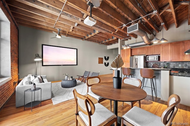 dining room featuring light wood-style floors, visible vents, and ceiling fan