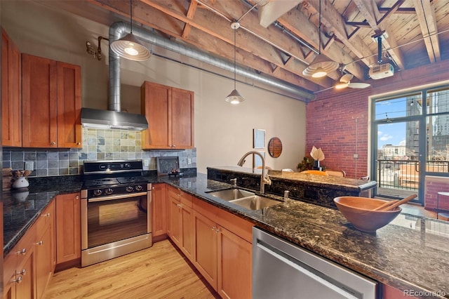 kitchen with tasteful backsplash, gas range, dishwasher, light wood-style floors, and a sink