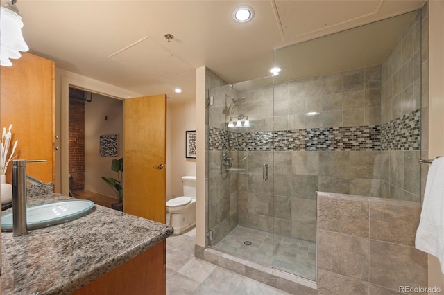 bathroom featuring vanity, a shower stall, toilet, and recessed lighting