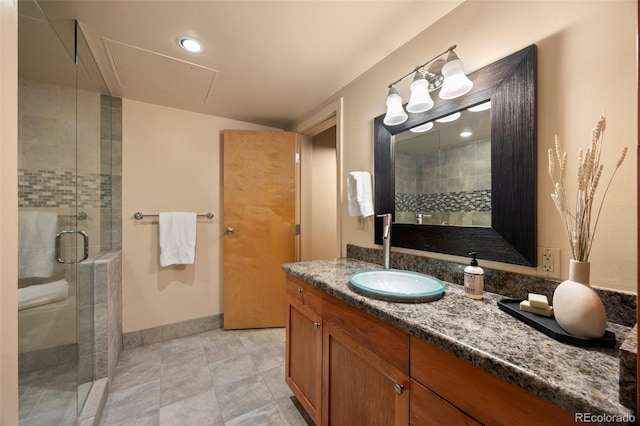 full bath featuring vanity, a shower stall, baseboards, and tile patterned flooring