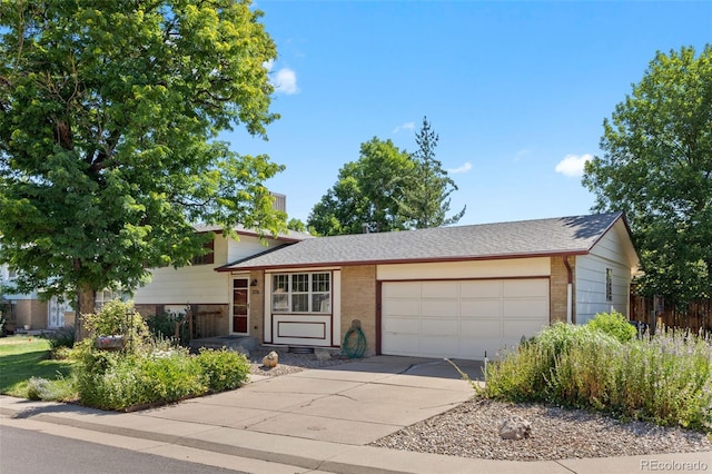 3176 S Alton Ct, Denver, CO 80231 - split level home with an attached garage, brick siding, and concrete driveway