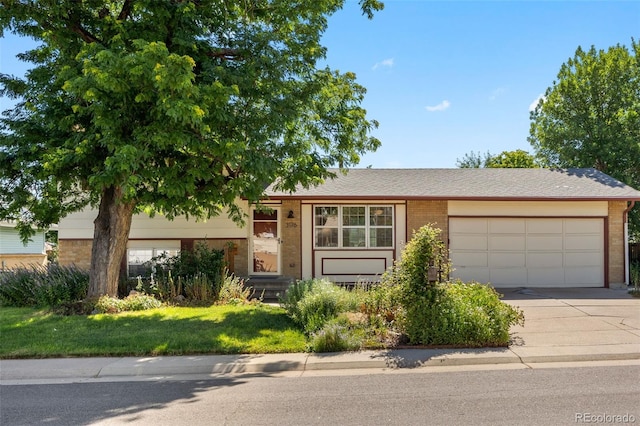 3176 S Alton Ct, Denver, CO 80231 - view of front of property with an attached garage, concrete driveway, and brick siding