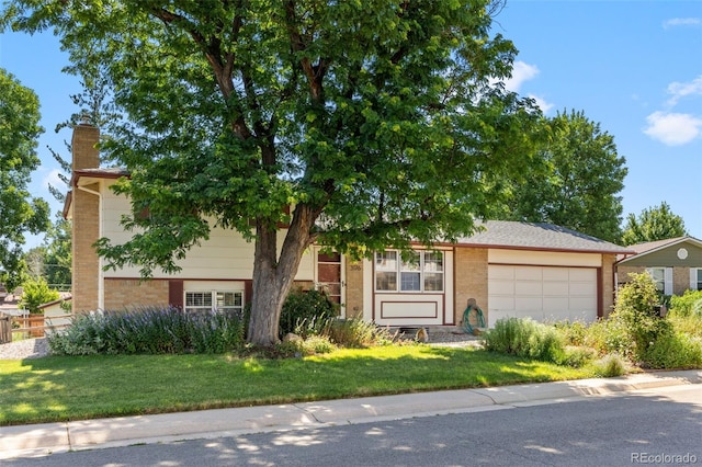3176 S Alton Ct, Denver, CO 80231 - view of front of property with brick siding, a garage, a chimney, and a front yard