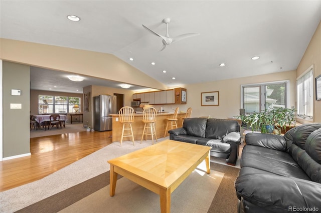 3176 S Alton Ct, Denver, CO 80231 - living area with lofted ceiling, recessed lighting, light carpet, light wood-style flooring, and a ceiling fan