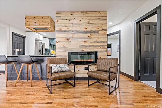 living room with light wood-type flooring and a fireplace