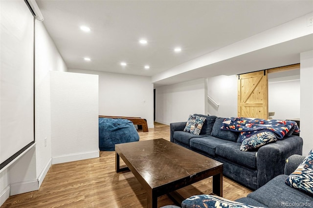 91 S Quantock St, Aurora, CO 80018 - living room featuring a barn door, light wood-style flooring, and recessed lighting