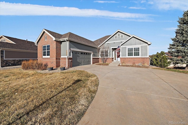 view of front of house with a front yard, an attached garage, brick siding, and driveway