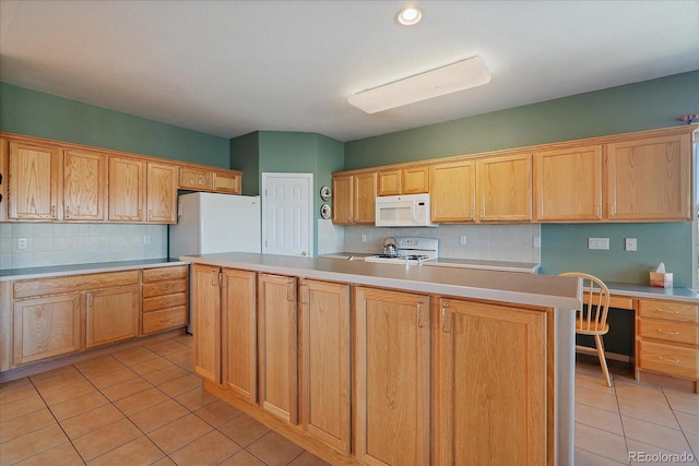 kitchen featuring white appliances, light tile patterned flooring, light countertops, and built in desk