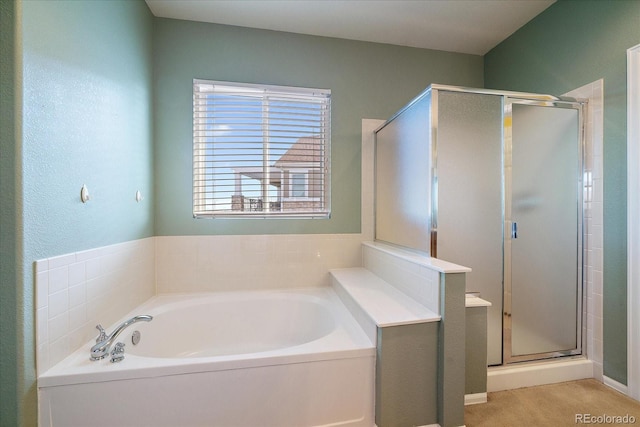 bathroom featuring a bath and a shower stall