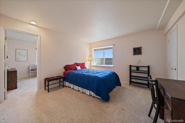 carpeted bedroom featuring baseboards