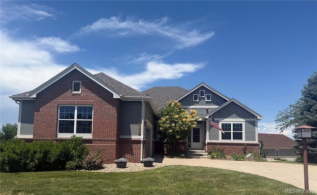 22725 E Long Dr, Aurora, CO 80016 - view of front facade featuring brick siding, a front lawn, driveway, and board and batten siding
