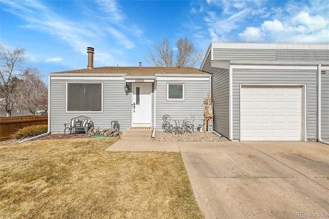 view of front of home featuring a garage and a front lawn