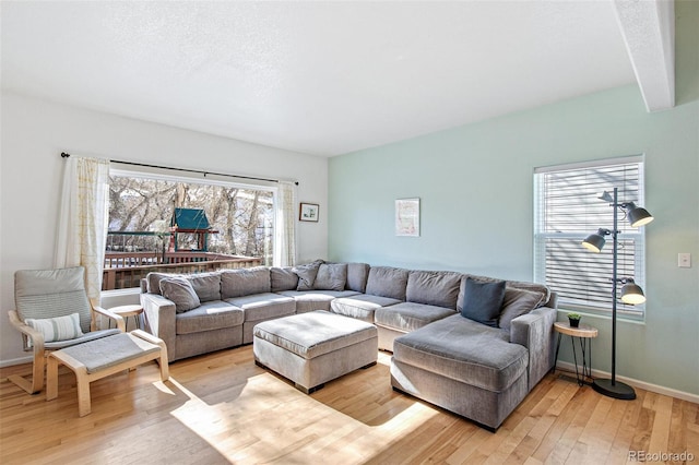 living room featuring a textured ceiling and light wood-type flooring