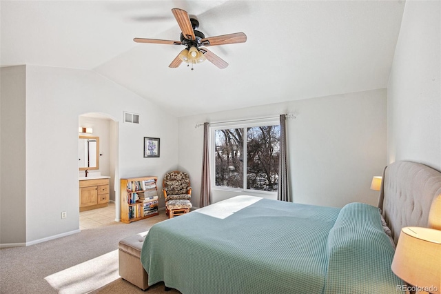 carpeted bedroom featuring ceiling fan, lofted ceiling, connected bathroom, and sink