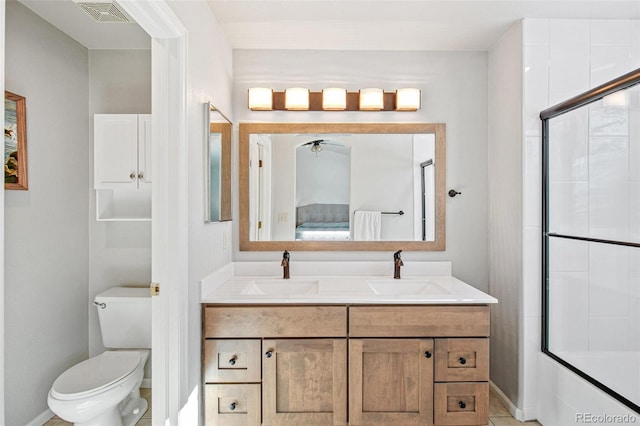 full bathroom with bath / shower combo with glass door, vanity, and toilet