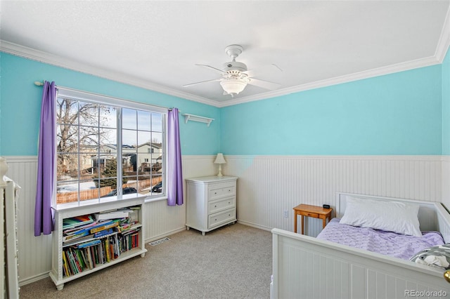 bedroom with ornamental molding, light carpet, and ceiling fan