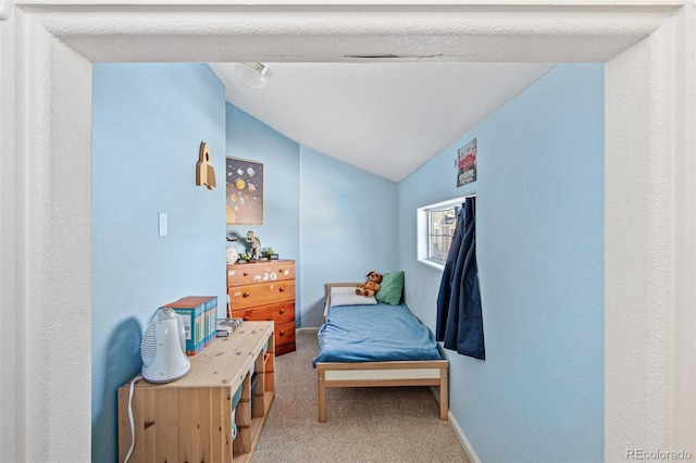 bedroom with lofted ceiling and light carpet