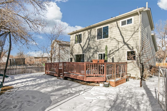 snow covered house with a deck