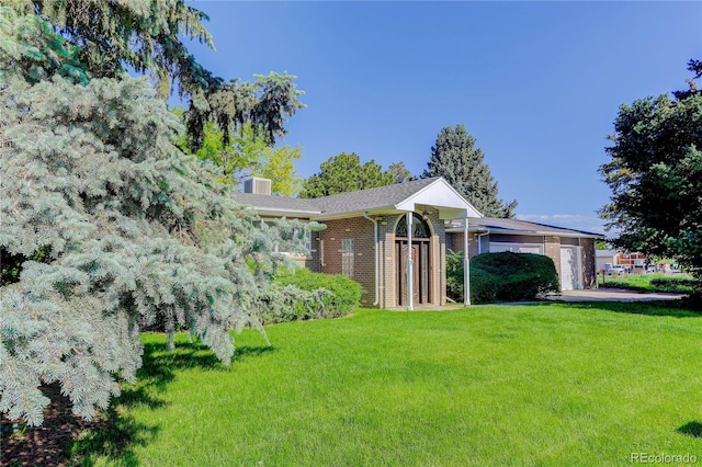 3561 Kalispell St, Aurora, CO 80011 - view of front of home featuring a front yard and brick siding