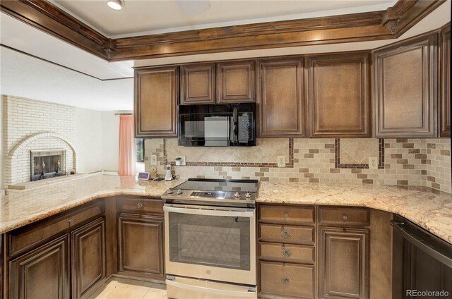 3561 Kalispell St, Aurora, CO 80011 - kitchen with stainless steel appliances, decorative backsplash, light stone countertops, dark brown cabinetry, and a peninsula