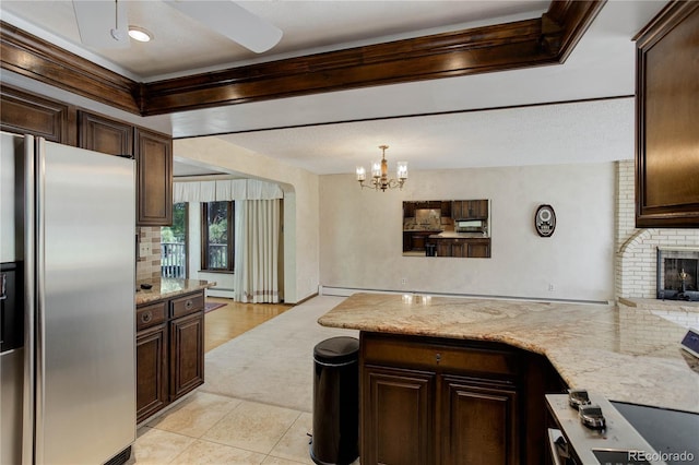 3561 Kalispell St, Aurora, CO 80011 - kitchen featuring stainless steel fridge, dark brown cabinetry, and a peninsula