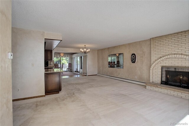3561 Kalispell St, Aurora, CO 80011 - unfurnished living room featuring a baseboard heating unit, a chandelier, a brick fireplace, light carpet, and a textured ceiling