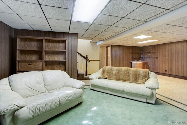3561 Kalispell St, Aurora, CO 80011 - living area with wood walls, carpet flooring, stairway, and baseboard heating