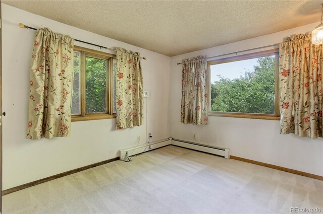 3561 Kalispell St, Aurora, CO 80011 - unfurnished room with a textured ceiling, carpet floors, and a baseboard heating unit