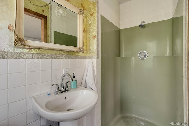 3561 Kalispell St, Aurora, CO 80011 - full bathroom with wallpapered walls, a stall shower, wainscoting, and tile walls