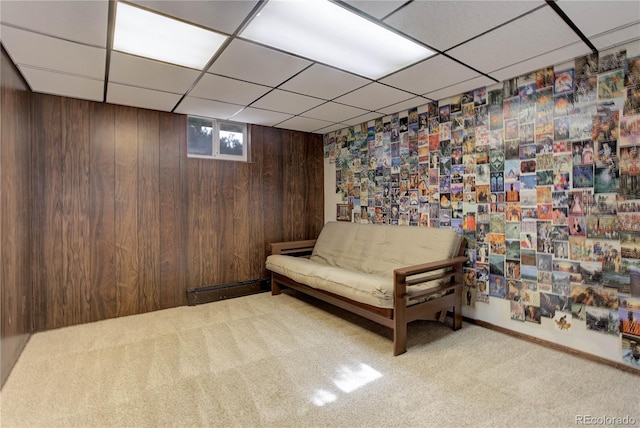 3561 Kalispell St, Aurora, CO 80011 - living area featuring a paneled ceiling, carpet, and wood walls
